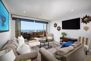 a living room with a couch and a flat screen tv at 700-104 Water Front Condo w AC in Oceanside