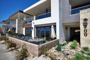 an external view of a house with an umbrella at 700-104 Water Front Condo w AC in Oceanside