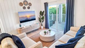 a living room with a couch and a tv at 2 BDM, 2 Bath - Bimini Bay Resort in Bailey Town