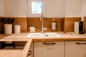 a kitchen counter with a sink and a microwave at Porto Nativo Split in Split +41 photos