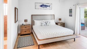 a bedroom with a bed and two night stands and a window at 2 BDM, 2 Bath - Bimini Bay Resort in Bailey Town +68 photos