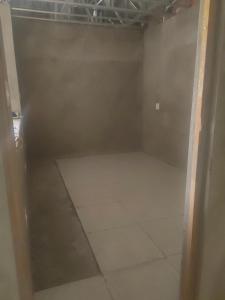 an empty closet with a white tile floor at The Ambience in Maseru