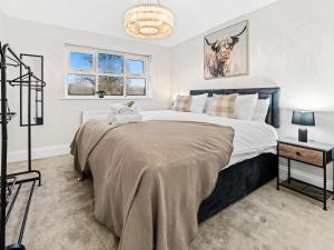 a bedroom with a large bed and a table at Spacious 3BR 3-Bath Modern Home Warrington in Warrington