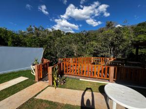 a wooden deck with a table and a table at Pousada do Rui in Caparaó Velho