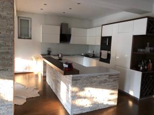 a kitchen with white cabinets and a counter top at NOVA residence in Sarajevo