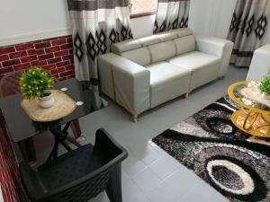 a living room with a couch and a table at Titi garage meublé in Yaoundé