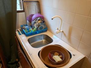 a kitchen counter with a sink next to a sink at Titi garage meublé in Yaoundé