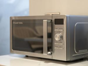 a microwave oven sitting on top of a counter at Spacious 3BR 3-Bath Modern Home Warrington in Warrington