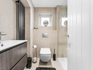 a bathroom with a toilet and a sink at Spacious 3BR 3-Bath Modern Home Warrington in Warrington