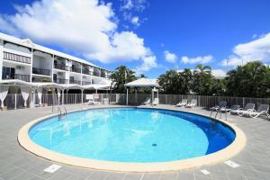 a large swimming pool in front of a hotel at Studio Les Marines V - calme - vue sur le golf in Saint-François