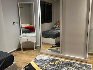 a mirror in a room with a bed and a bedroom at One Bedroom Apartment - Port Said Sea View Chalet in Port Said
