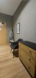 a bedroom with a bed and a chair in a room at Amber Single Room17 Self Check-In Accommodation in Hull