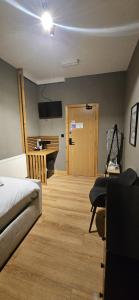 a bedroom with a bed and a desk and a table at Amber Single Room17 Self Check-In Accommodation in Hull