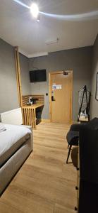 a bedroom with a bed and a desk and a table at Amber Single Room17 Self Check-In Accommodation in Hull