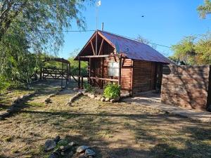 a small wooden cabin with a red roof at Cabañas Lumel in Carpintería