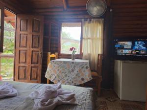 a bedroom with a table and a bed and a window at Cabañas Lumel in Carpintería +1 photo
