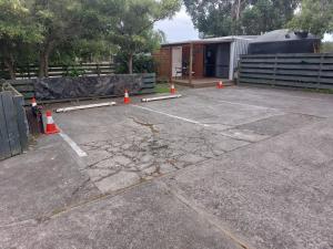 a parking lot with orange cones and a building at Rural in the city in Palmerston North