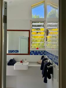 a white bathroom with a sink and a window at The Pointe Taveuni in Matei +56 photos