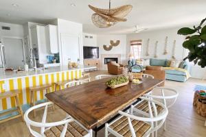 a kitchen and living room with a wooden table and chairs at Bayou Breeze Retreat in Orange Beach