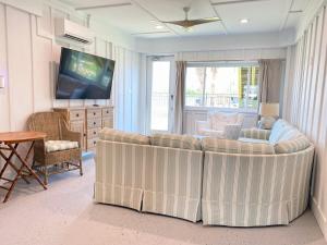 a living room with a couch and a television at Bayou Breeze Retreat in Orange Beach