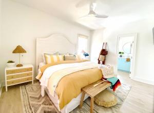 a bedroom with a large bed with a yellow blanket at Bayou Breeze Retreat in Orange Beach +83 photos