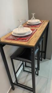 a wooden table with two plates on top of it at Full Studio in Stella Maris in Salvador