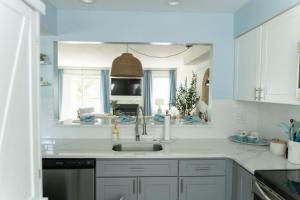 a white kitchen with a sink and a window at 114 Austin Ave, Unit 11 in Wildwood +22 photos