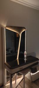 a mirror on a table with a bottle on it at كومباوند وصال الشروق in Madīnat ash Shurūq +1 photo