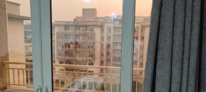 a view of a large building from a window at كومباوند وصال الشروق in Madīnat ash Shurūq
