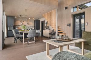 a dining room and kitchen with a table and chairs at Hoda Cabin - Luxury lodge with jacuzzi and sauna in Lyngværet +96 photos