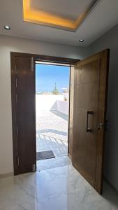 a door to a room with a view of a patio at Villa neuve avec une grande terrasse in Dar Tahar Zaouch