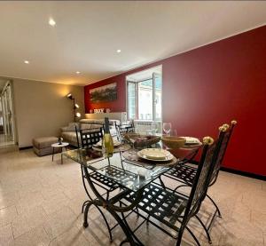 a dining room with a table and chairs and a couch at Como Lake, lakefront 30m in Como