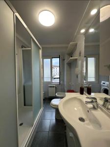 a bathroom with a sink and a shower and a toilet at Como Lake, lakefront 30m in Como +8 photos