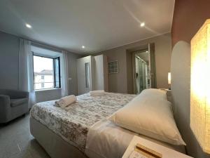 a bedroom with a large bed and a window at Como Lake, lakefront 30m in Como