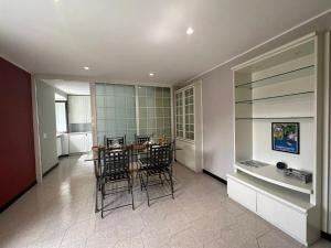 a kitchen and dining room with a table and chairs at Como Lake, lakefront 30m in Como