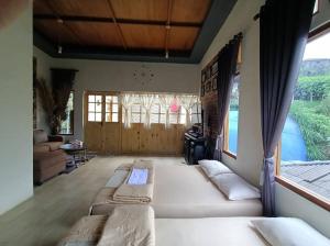 a living room with a large white couch in a room at Vany GLAMPING in Pasuruan