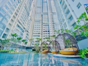 a group of bird cages in front of a tall building at Happy One Central in Trạm Chánh An