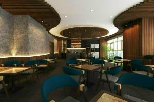 a restaurant with wooden tables and blue chairs at Happy One Central in Trạm Chánh An