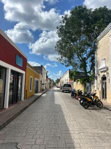 a street with motorcycles parked on the side of a street at Casa Ich in Valladolid
