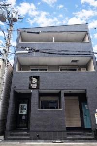 a black brick building with a sign on it at b&岸里店 in Osaka