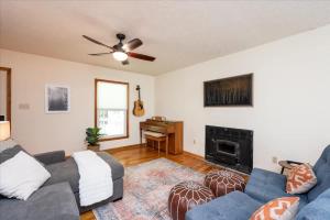 een woonkamer met een bank en een open haard bij Quiet Retreat - Piano Firepit Peloton in Pittsboro