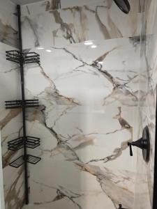a bathroom with a marble shower stall with a shower at Private Garden Suite in Bayshore in Bay Shore +20 photos