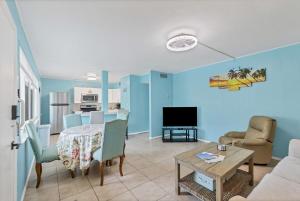 a living room with a table and a dining room at 2BR Renovated Siesta Key Condo, beach and pool access in Sarasota