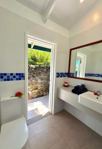 a bathroom with two sinks and a mirror at The Pointe Taveuni in Matei +64 photos