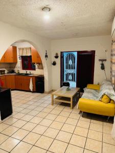 a living room with a yellow couch and a table at Tulli Private house in San Juan in San Juan
