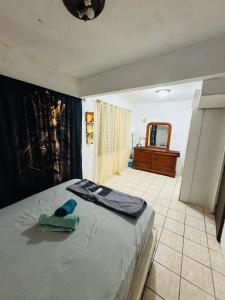 a bedroom with a bed and a bathroom with a mirror at Tulli Private house in San Juan in San Juan