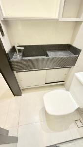 a bathroom with a white toilet in a room at Flat Premium bairro nobre in Imperatriz