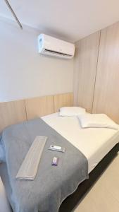 a hospital room with a bed with a blanket at Flat Premium bairro nobre in Imperatriz