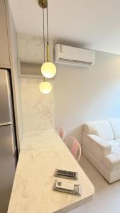 a living room with a table and a couch at Flat Premium bairro nobre in Imperatriz +20 photos