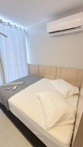 En eller flere senge i et værelse på Flat Premium bairro nobre